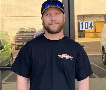 Technician standing in front of SERVPRO office