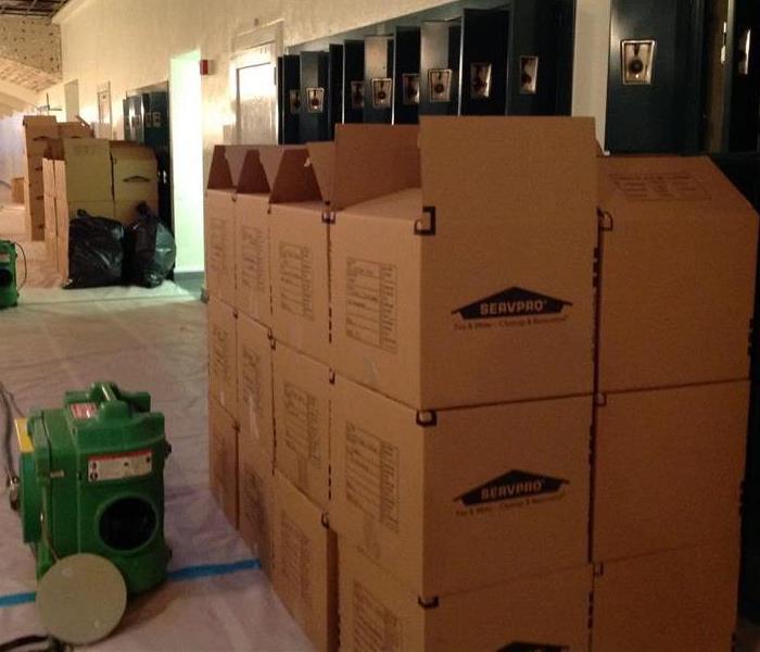 Storage boxes stacked on top of each other in a hallway. 